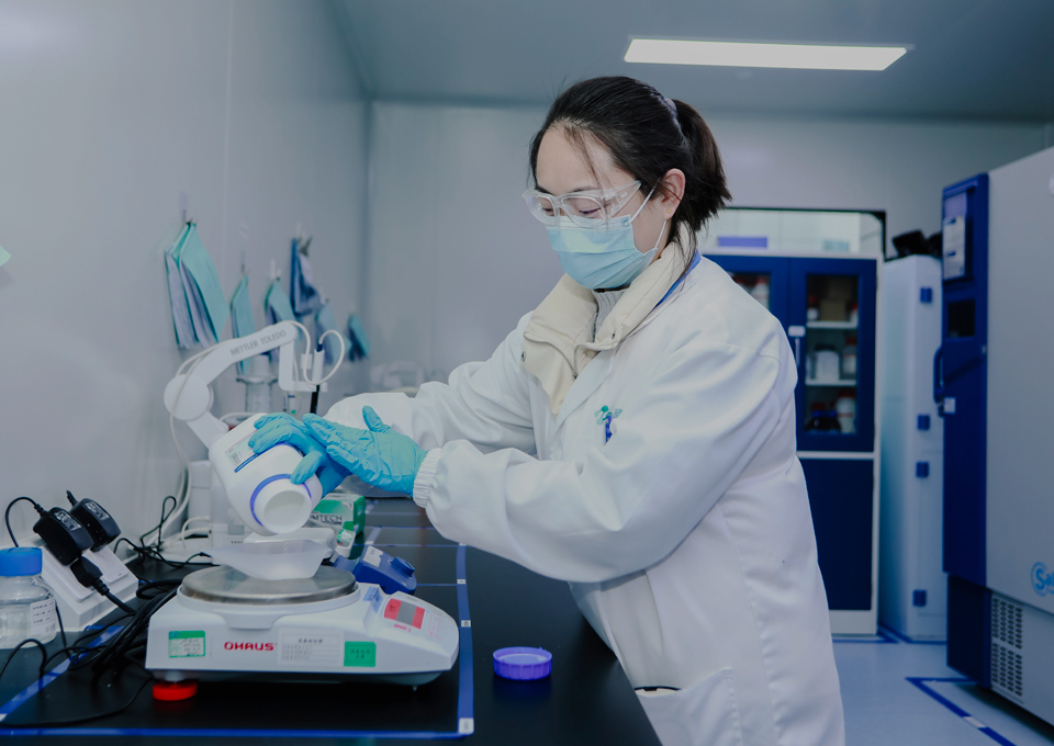 Laboratory staff operating a liquid handling workstation